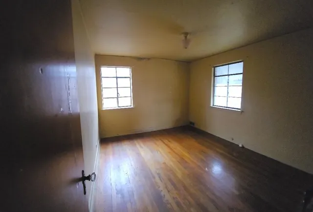 a view of a house with wooden fence