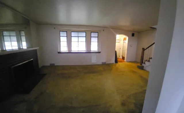 a view of empty room with a fireplace