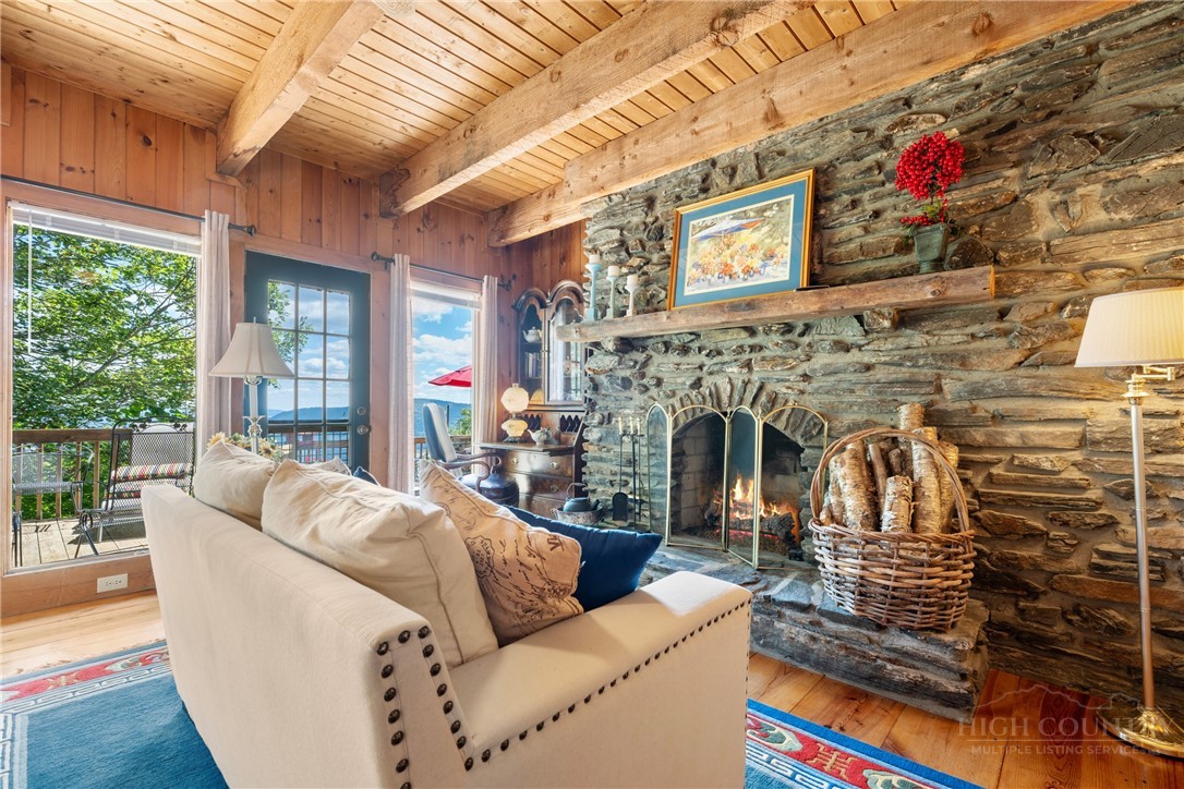2177 Homestead Road Todd, NC 28684 - Photo 14 of 49 a living room with furniture fireplace and a large window