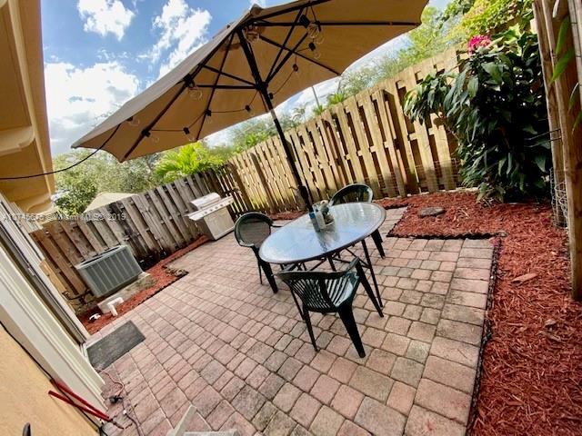 12999 Southwest 132nd Terrace, Unit 12999 Miami, FL 33186 - Photo 13 of 23 a patio with table and chairs
