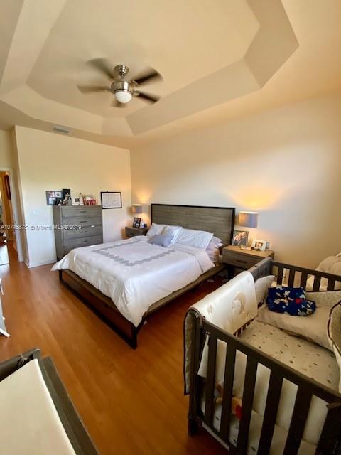 12999 Southwest 132nd Terrace, Unit 12999 Miami, FL 33186 - Photo 15 of 23 a bedroom with two beds and painting on the wall