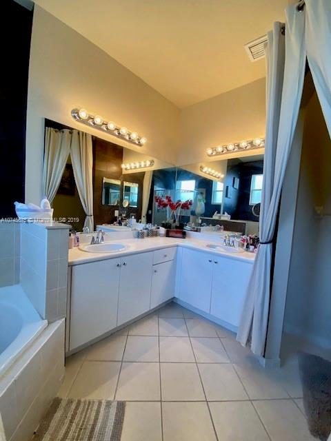 12999 Southwest 132nd Terrace, Unit 12999 Miami, FL 33186 - Photo 18 of 23 a kitchen with a sink a counter top space stainless steel appliances and cabinets