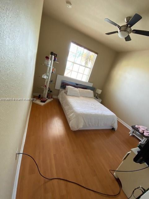 12999 Southwest 132nd Terrace, Unit 12999 Miami, FL 33186 - Photo 20 of 23 a bedroom with a bed and window