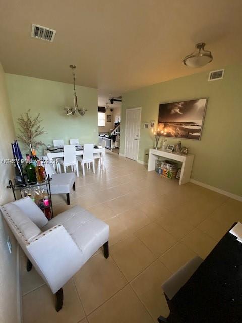 12999 Southwest 132nd Terrace, Unit 12999 Miami, FL 33186 - Photo 4 of 23 a living room with furniture and a kitchen