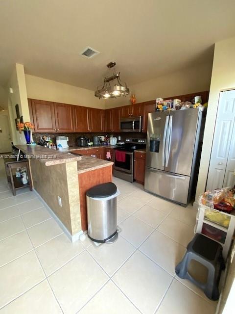 12999 Southwest 132nd Terrace, Unit 12999 Miami, FL 33186 - Photo 10 of 23 a kitchen with stainless steel appliances granite countertop a refrigerator stove and sink