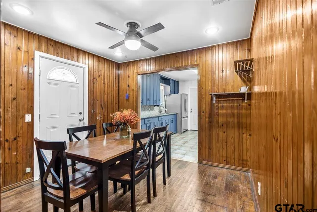 a view of a a dining room with furniture window and wooden floor