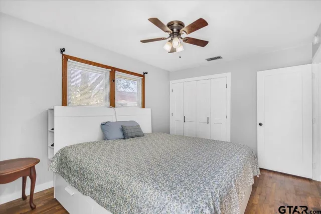a bedroom with a large bed and a chandelier