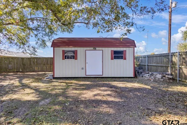 a view of a backyard with a tree
