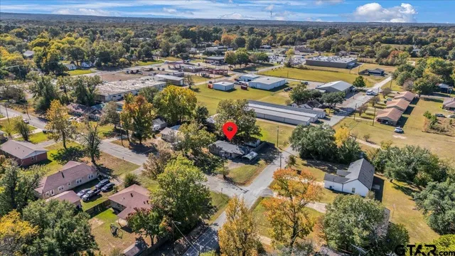 an aerial view of residential houses with outdoor space and lake view