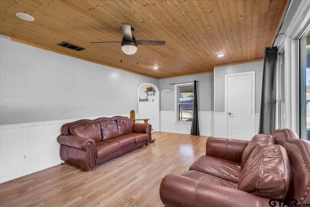 a living room with furniture ceiling fan and a rug