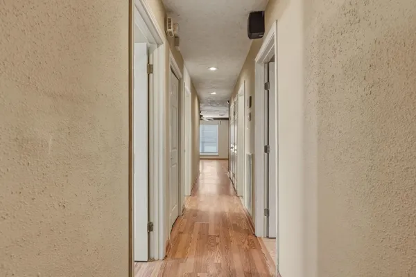 a view of hallway with wooden floor