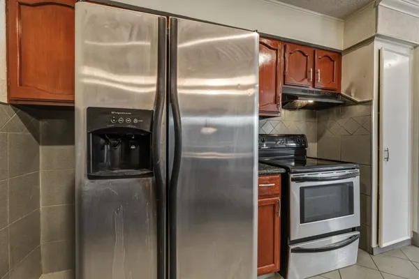 a kitchen with a refrigerator and cabinets