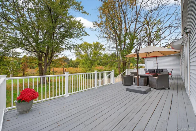 a view of a deck with furniture and wooden floor