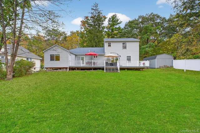 a front view of a house with a yard and trees