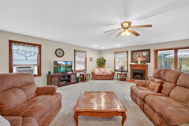 a living room with furniture a fireplace and a window