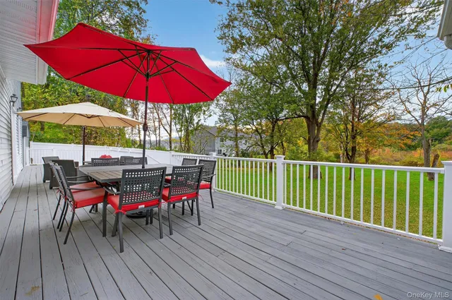 a view of deck with furniture and umbrella
