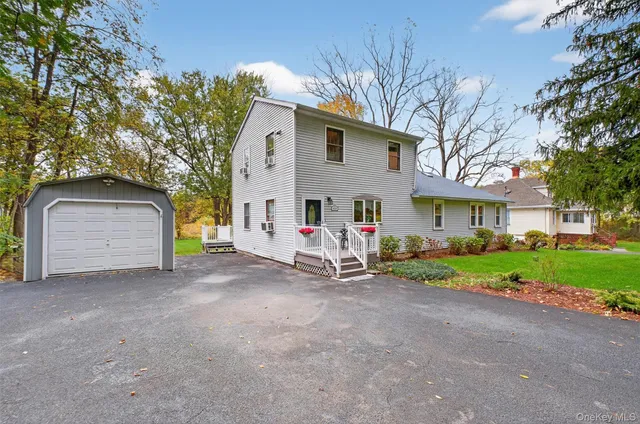 a view of a house with a yard and garage