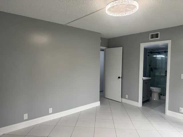 a view of an empty room and closet area