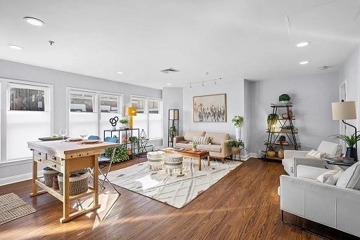 a living room with furniture and wooden floor