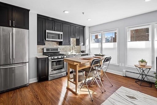 1 Davenport Street, Unit 2 Cambridge, MA 02140 - Photo 3 of 13 a kitchen with stainless steel appliances a stove a sink refrigerator and microwave