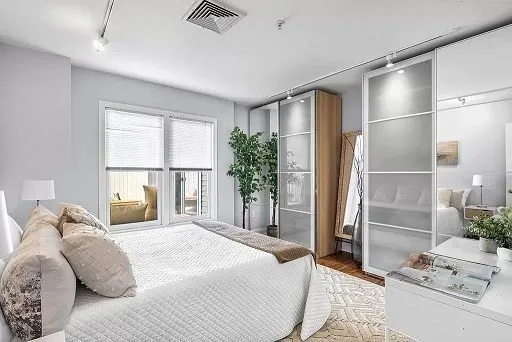 a bedroom with a large bed and a window