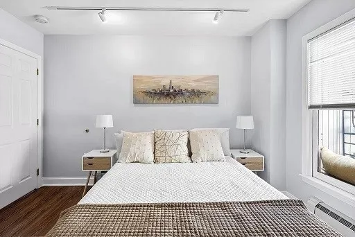 a bedroom with a bed and a window