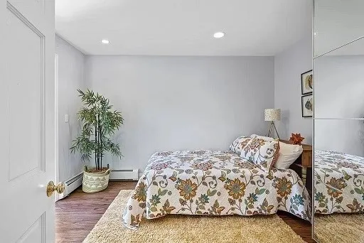 a bedroom with a bed and a potted plant