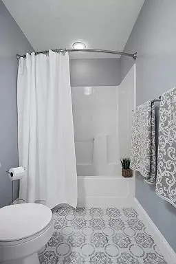 a bathroom with a shower and a toilet