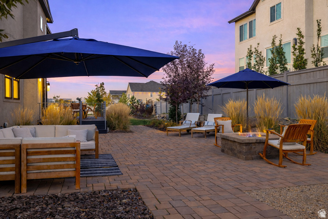 11617 South Wildrye Field Way Draper, UT 84020 - Photo 40 of 53 Patio terrace at dusk with a patio, a fenced backyard, and an outdoor living space with a fire pit