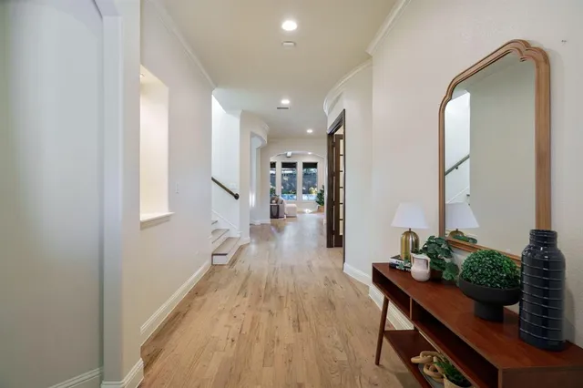 a hallway with wooden floor and furniture