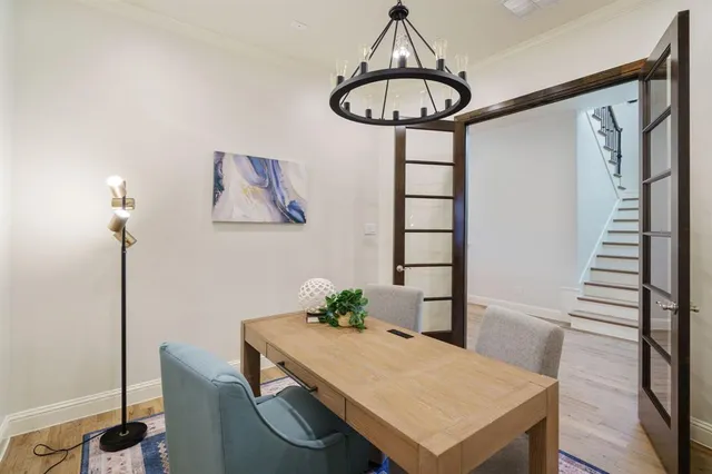 a view of a dining room with furniture wooden floor and a chandelier