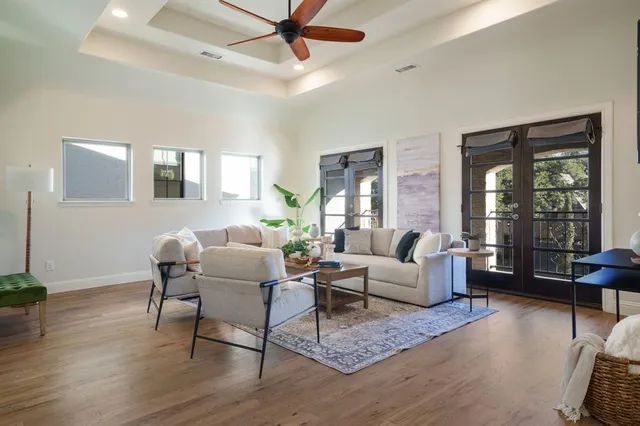 a living room with furniture and wooden floor