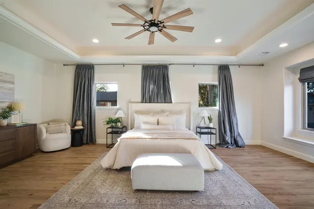 a spacious bedroom with a bed and a chandelier