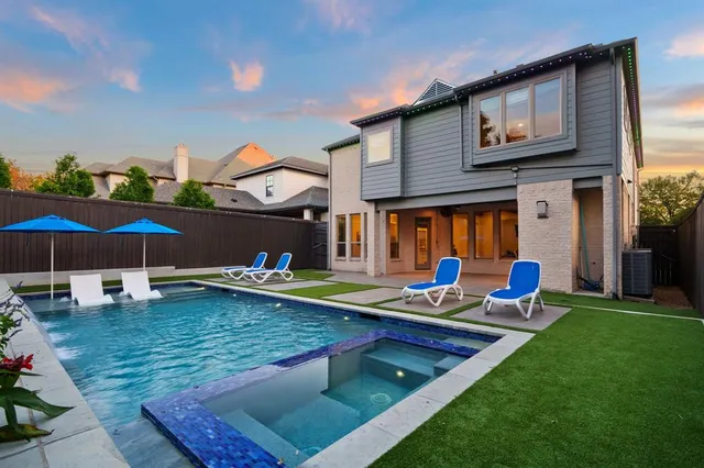 a view of a house with backyard sitting area and furniture
