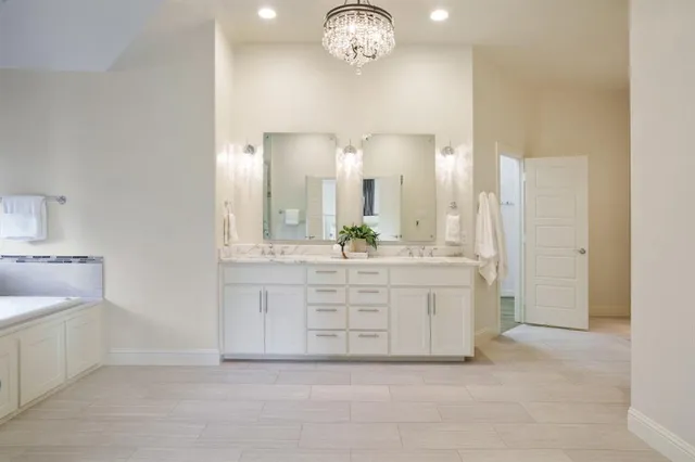 a bathroom with a double vanity sink and a mirror