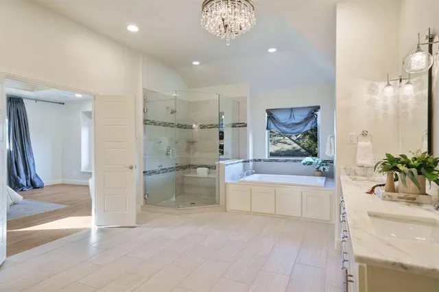 a spacious bathroom with a granite countertop tub shower and sink