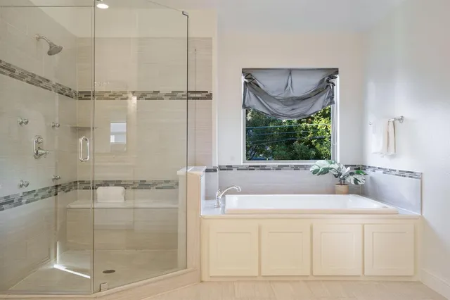 a bathroom with a bathtub and a shower