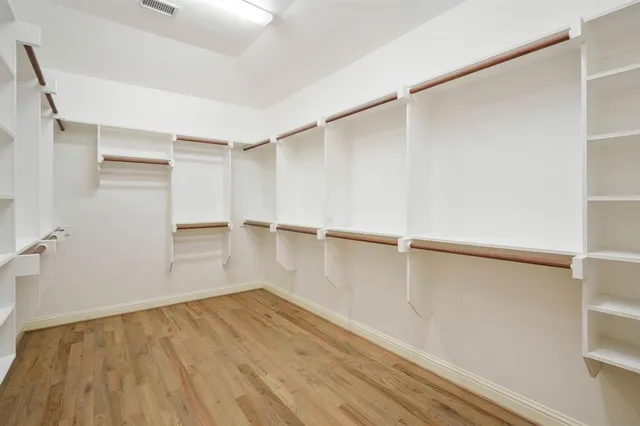 a view of a room with wooden floor