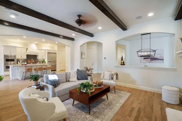 a living room with furniture and view of kitchen