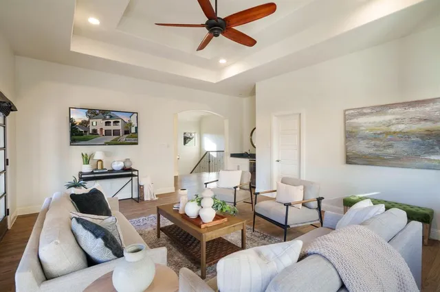 a living room with furniture and a ceiling fan