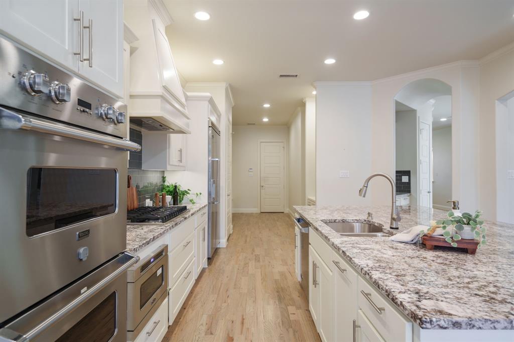 6211 Velasco Avenue Dallas, TX 75214 - Photo 6 of 38 a spacious kitchen with stainless steel appliances granite countertop a sink and a stove