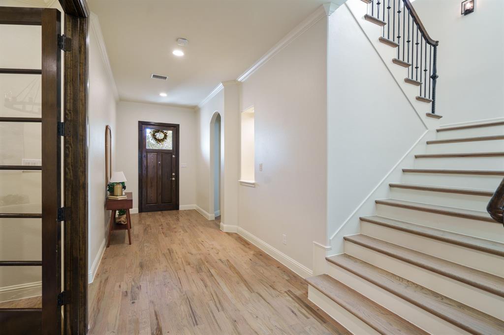 6211 Velasco Avenue Dallas, TX 75214 - Photo 10 of 38 a view of a hallway with wooden floor and staircase