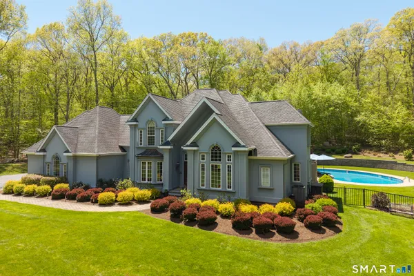 a front view of house with yard and green space