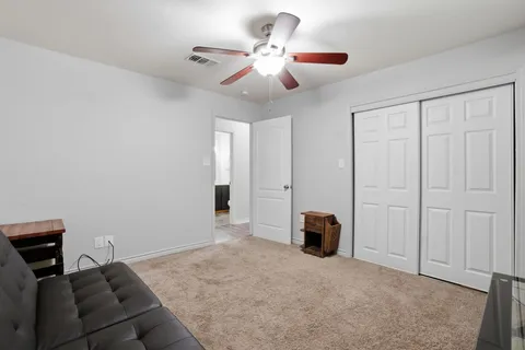 a living room with furniture and a ceiling fan