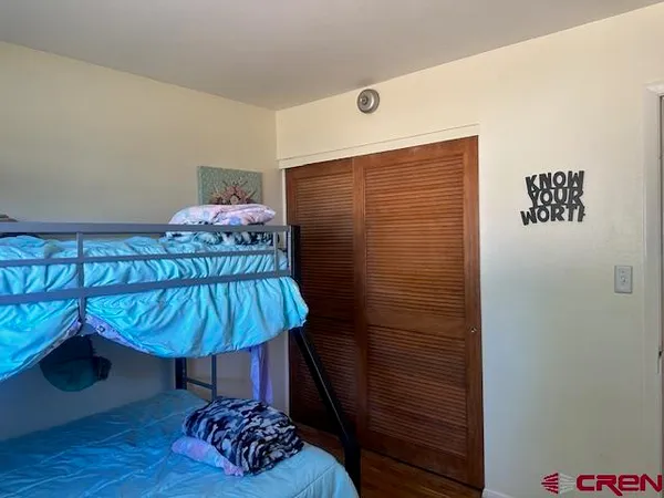 a bedroom with a bed and a table