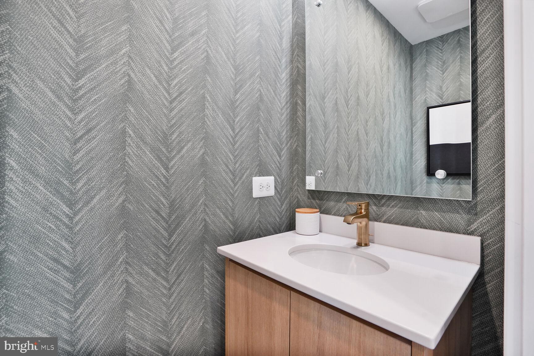 61 Lower Service Road Northwest, Unit 877 Washington, DC 20422 - Photo 12 of 21 a bathroom with a sink and a mirror