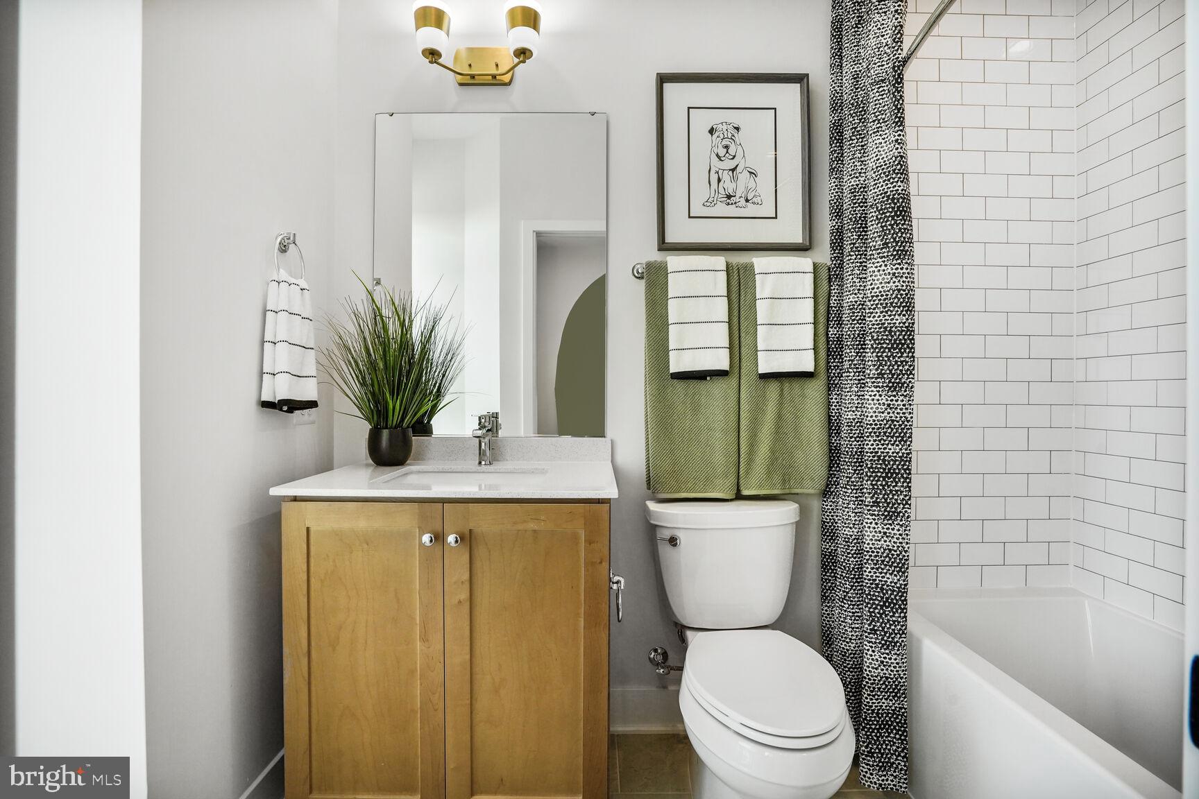 61 Lower Service Road Northwest, Unit 877 Washington, DC 20422 - Photo 14 of 21 a bathroom with a toilet a sink and a shower