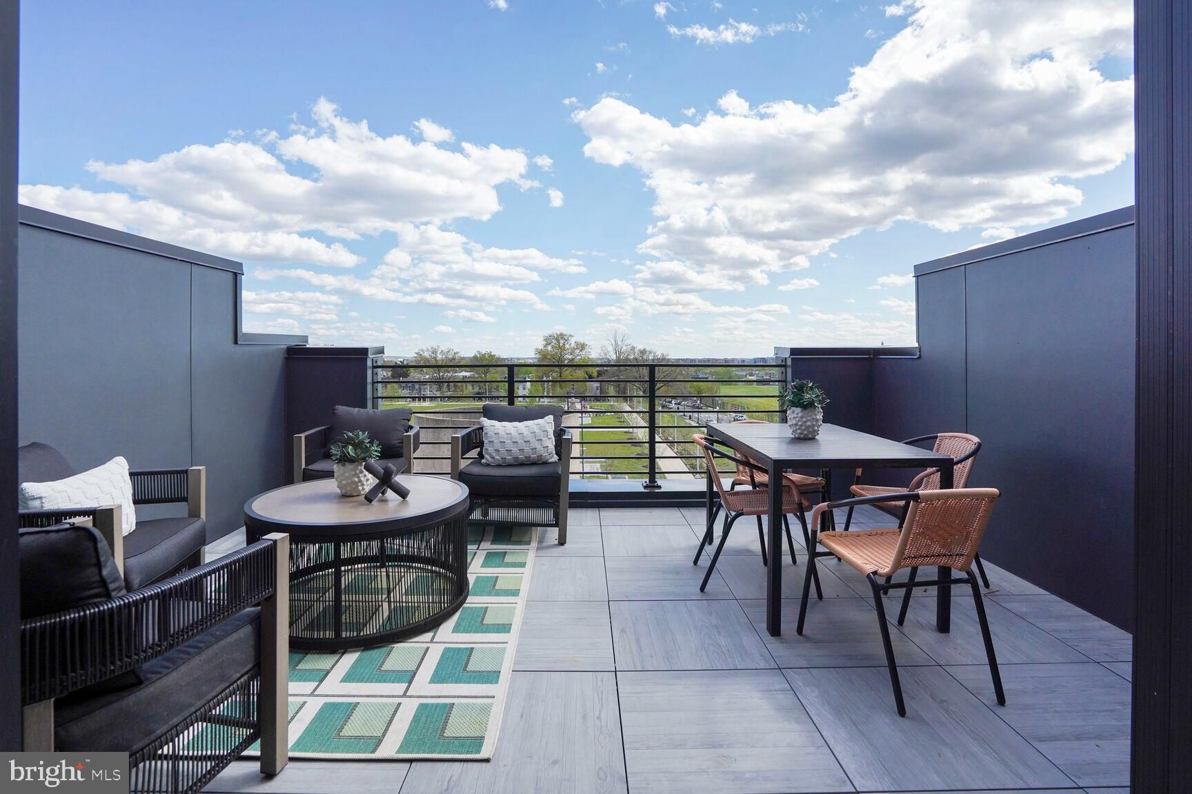 61 Lower Service Road Northwest, Unit 877 Washington, DC 20422 - Photo 21 of 21 a terrace with outdoor seating and city view