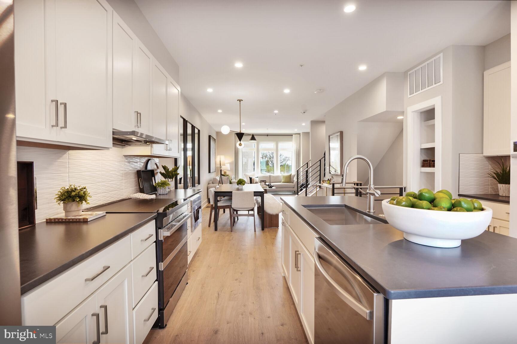 61 Lower Service Road Northwest, Unit 877 Washington, DC 20422 - Photo 7 of 21 a kitchen with a sink a stove and chairs