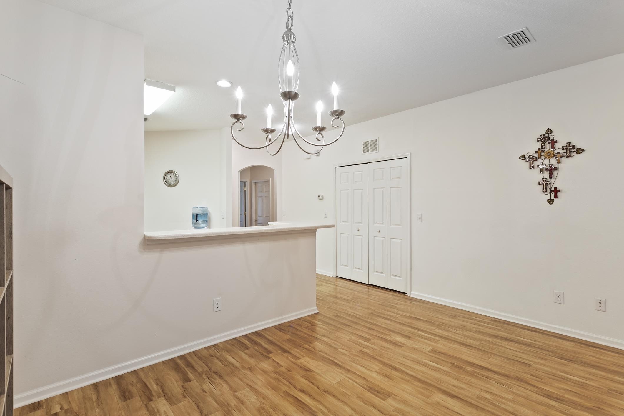 554 Wooded Crossing Circle St. Augustine, FL 32084 - Photo 13 of 43 a view of an empty room with wooden floor and a window